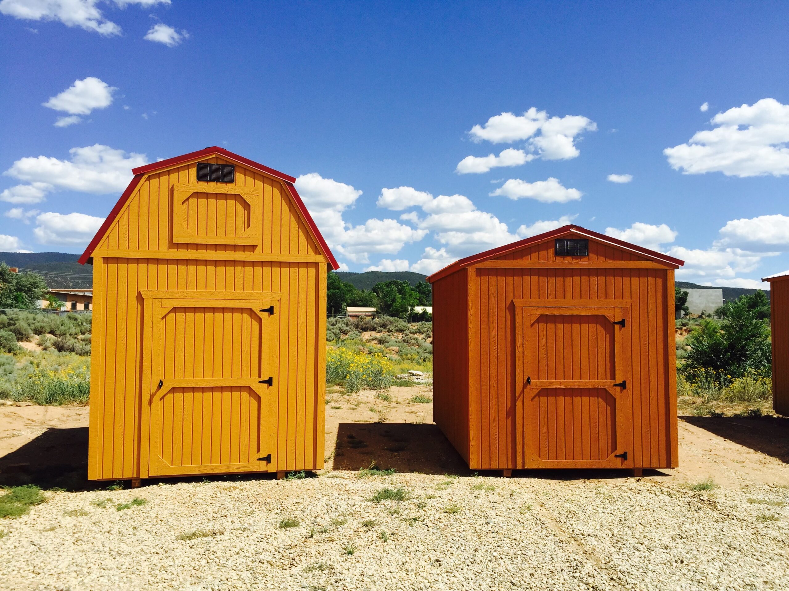 two sheds next to each other. one shed has seminole cedar coated on it, the other has seminole red coated on it.
